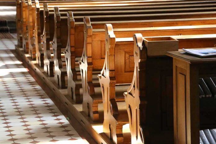 wooden church pews in sunlight