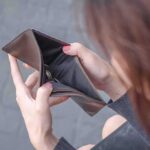 Poll Shock: Wallets Wave White Flag Hands holding an open empty wallet