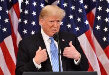 Plaza Hotel Night – Explosive Hill Report Targets Trump Donald Trump speaking at a podium with American flags behind him