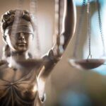 Privacy Bid Nuked In Abortion Trial Lady Justice statue holding scales