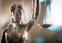 Privacy Bid Nuked In Abortion Trial Lady Justice statue holding scales