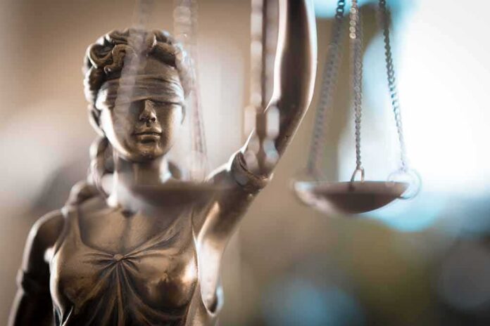 shutterstock_1220844322 Lady Justice statue holding scales