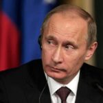 Putin Folds: American Walks Out, No Swap man in suit with earpiece at a conference