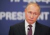 Vladimir Putin at a podium with microphone