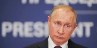 Vladimir Putin at a podium with microphone
