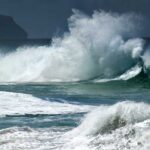 Iconic Arch Gone – Rangers Sound Alarm Crashing ocean waves against the shore under a cloudy sky
