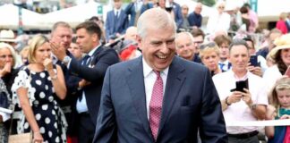Prince Andrew, Duke of York smiling in a crowd at an outdoor event