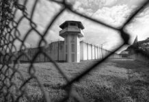 Vegas Court CRUSHES Tupac Plot Boss Prison watchtower behind chain-link fence