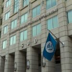 Atlanta ICE Attack Botched – Suspect Vanishes U.S. government building facade with American and blue departmental flags