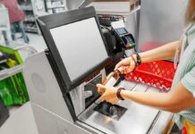 Self-Checkout Vanishes: Goodbye Convenience, Hello Surveillance Shopper scans a bottle at a self-checkout kiosk