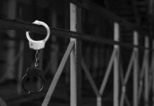 Prison Chaos? Diddy’s Midnight Hospital Dash handcuffs hanging on a metal railing