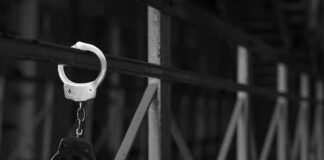 handcuffs hanging on a metal railing