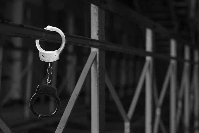 handcuffs hanging on a metal railing