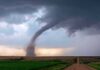 Deadlier Tornado Alley Creeps South Tornado touching down over open farmland under dark storm clouds