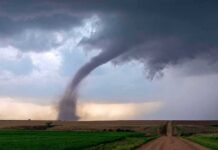 Deadlier Tornado Alley Creeps South Tornado touching down over open farmland under dark storm clouds