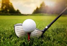 Judge Slams Weekend Chop – HALT Ordered A golf ball on a tee with a golf club resting beside it on green grass
