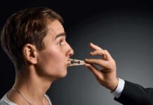 Democrats Eye Speech Controls – First Amendment Flashpoint Man in profile with a clothespin on his lips