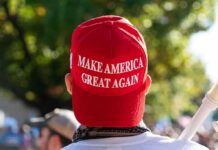 Backlash Explodes – MAGA Picks Up The Tab person wearing a red baseball cap at an outdoor gathering