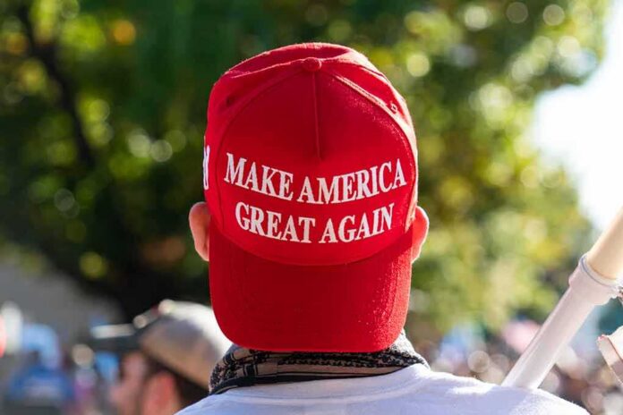 shutterstock_1850438311 person wearing a red baseball cap at an outdoor gathering