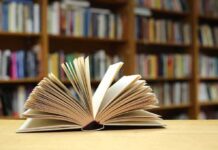 Bestseller Vanishes After Terror Pledge Open book on a table in a library