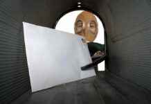Letter inside a mailbox with a person wearing a gas mask outside