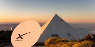 Starlink satellite dish near a pyramid-shaped building at sunset