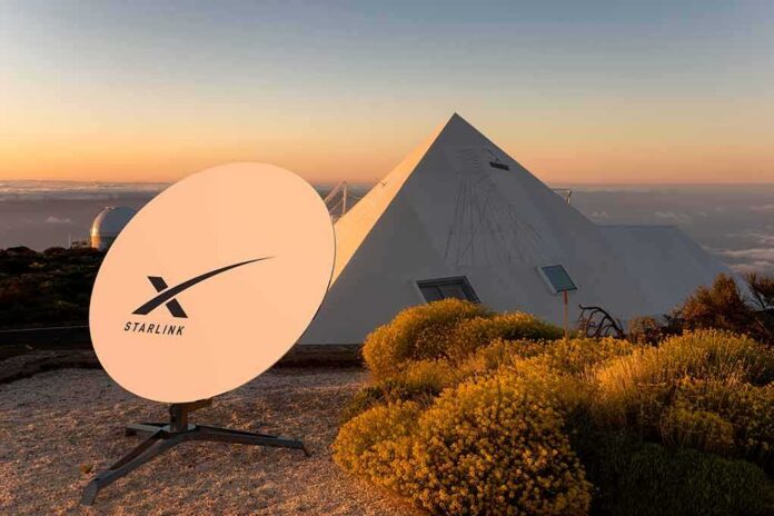 shutterstock_2133739611-1 Starlink satellite dish near a pyramid-shaped building at sunset