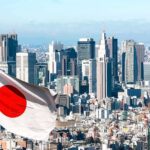 Japanese flag waving with modern city skyline in background