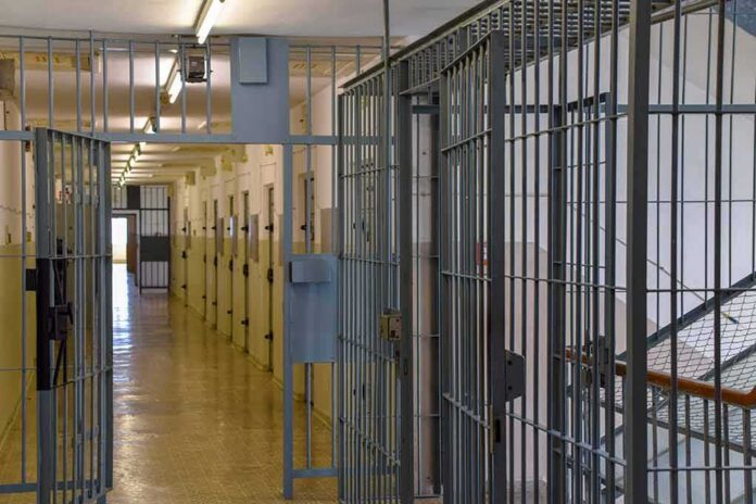 shutterstock_2284784009-2 Prison corridor with barred doors