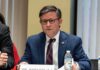 GOP Revolts Over ‘Execution TV’ A public official speaking at a meeting with a nameplate in front of him
