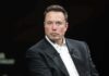 Elon Musk in a dark suit during an onstage talk