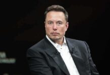Elon Musk in a dark suit during an onstage talk