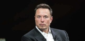 Elon Musk in a dark suit during an onstage talk
