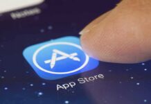 Finger tapping App Store icon on a smartphone screen