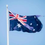 Deliberate Crash Stuns Australia’s Politics – Court Hears Chilling Attack Australian flag waving on a flagpole