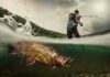 AI Fish Hoax – Clout Chasers Rig The Waters angler fighting a large fish in a split-level water shot