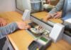 Bank teller hands cash to customer through security window