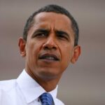 Strait Showdown: Obama Claims Iran Calls Shots Person speaking at a microphone, identified as Madelyn Dunham