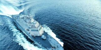 Naval warship cutting through open sea